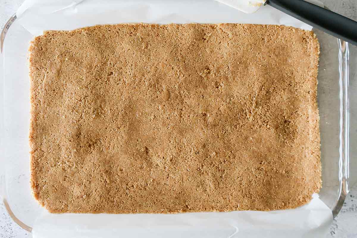 graham cracker and almond crust in a baking pan