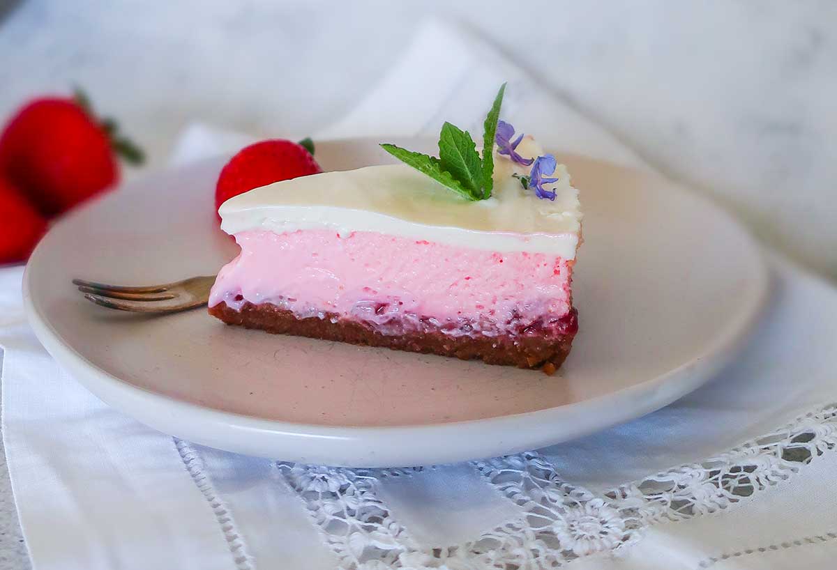 slice of 4 layer strawberry cheesecake