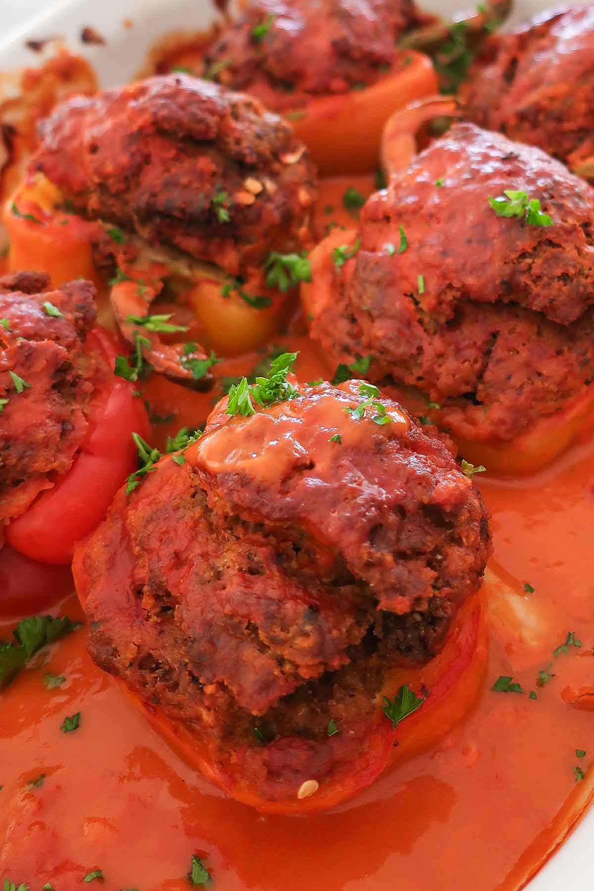 close up of baked stuffed pepper with tomato sauce