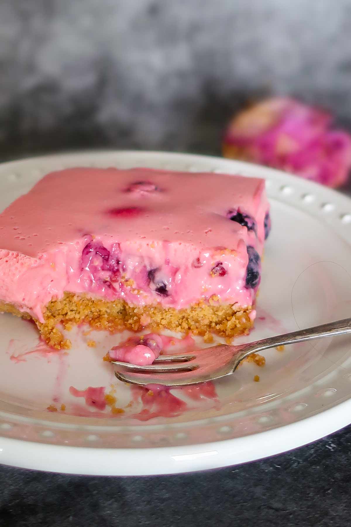 cross section of gluten-free no-bake berry cream bar on a plate