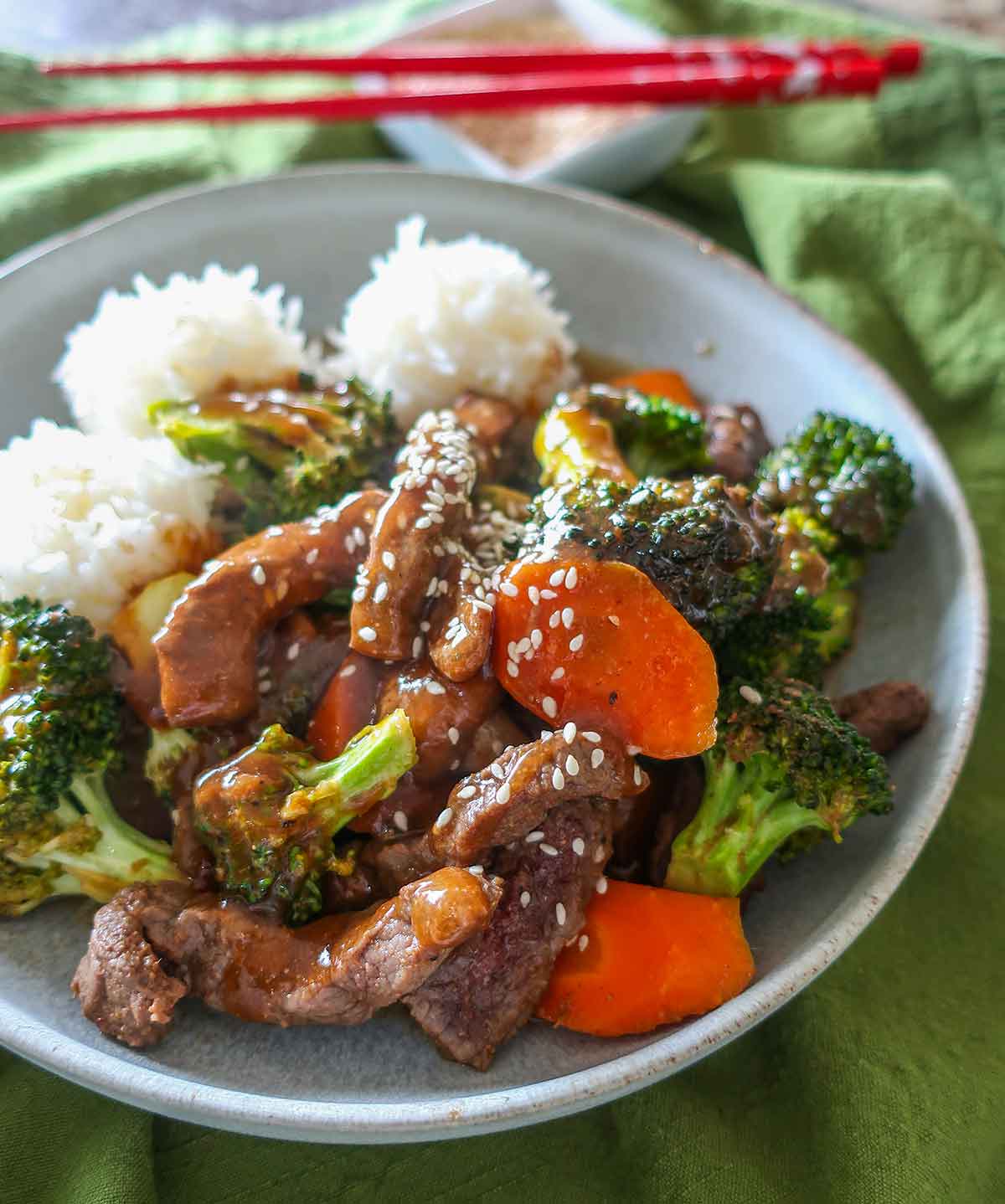 close up of beef and broccoli topped with sesame seeds