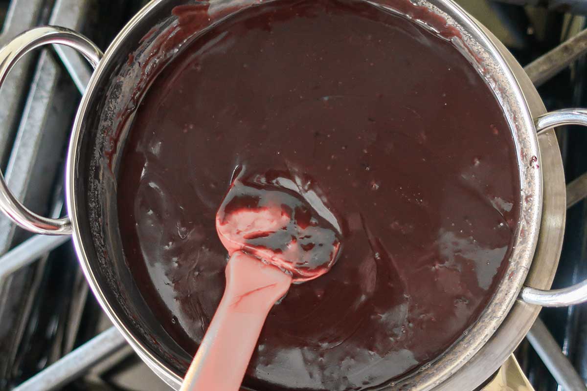 making chocolate sauce in a sauce pan for the center of molten cookies