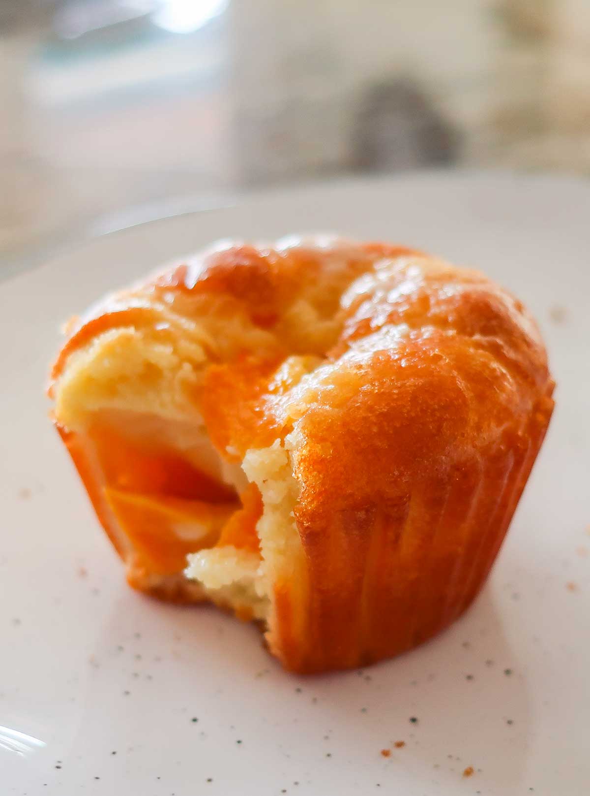 showing inside a peach pudding muffin