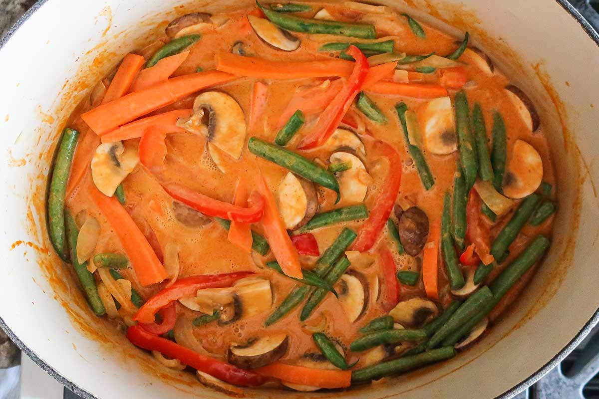 thai chicken curry simmering in a skillet