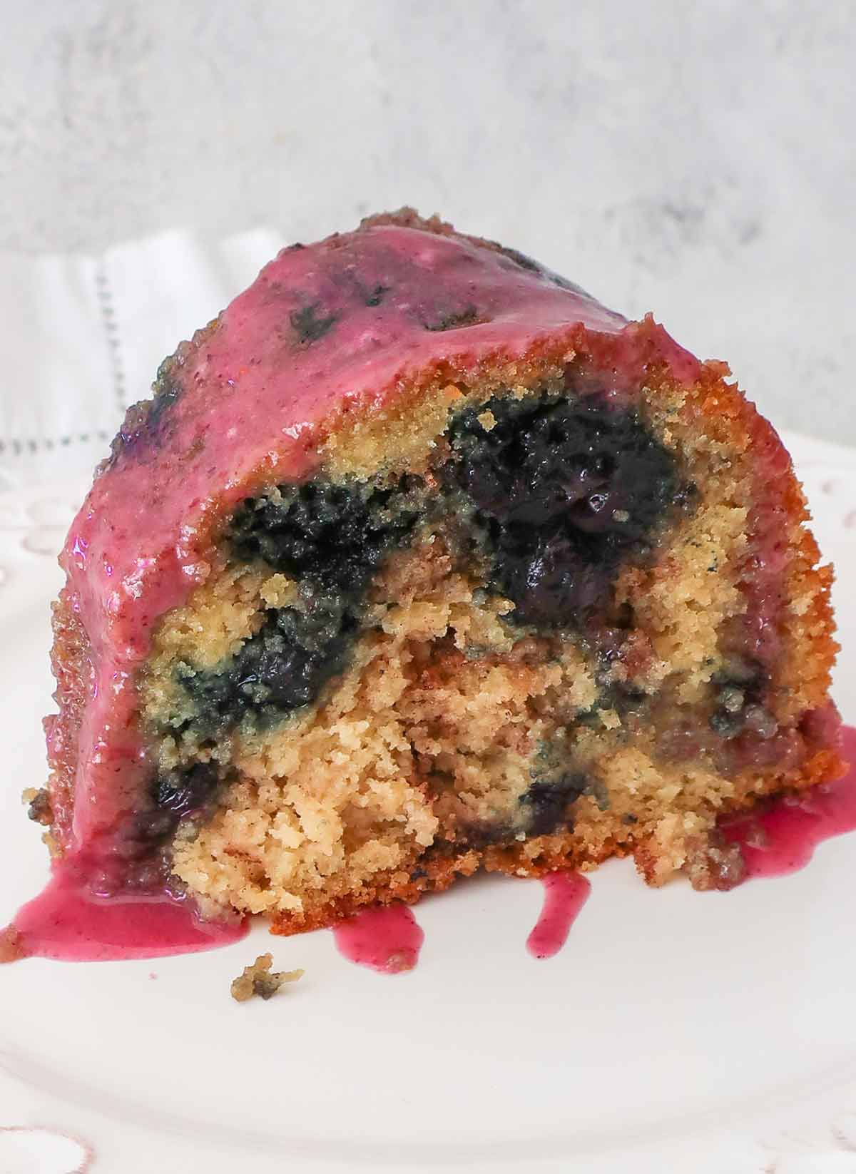 slice of gluten free blueberry bundt cake on a plate