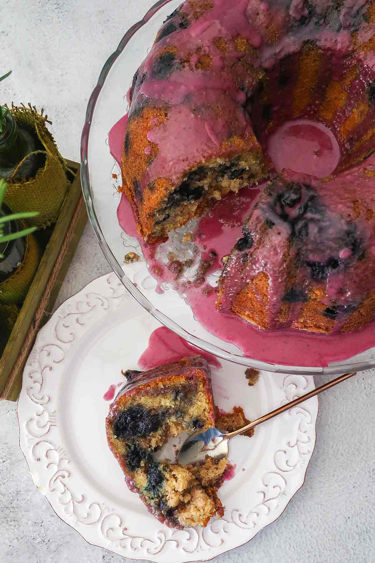 sliced blueberry bundt cake with a piece of cake on a plate