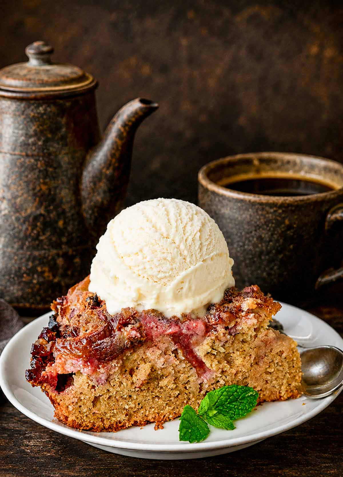 slice of gluten free plum skillet cake with dollop of vanilla ice cream