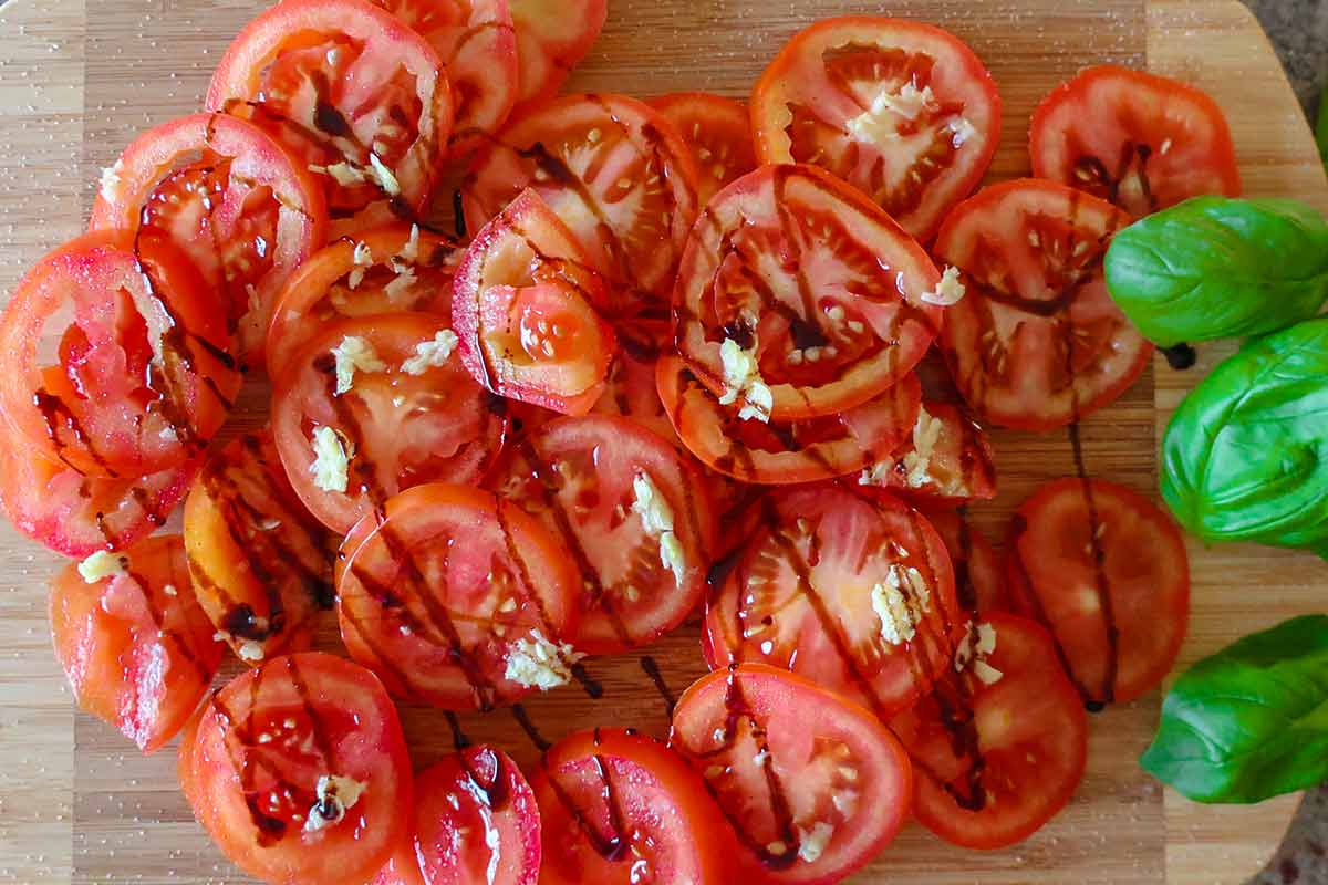 sliced tomatoes drizzled with balsamic glaze and chopped garlic