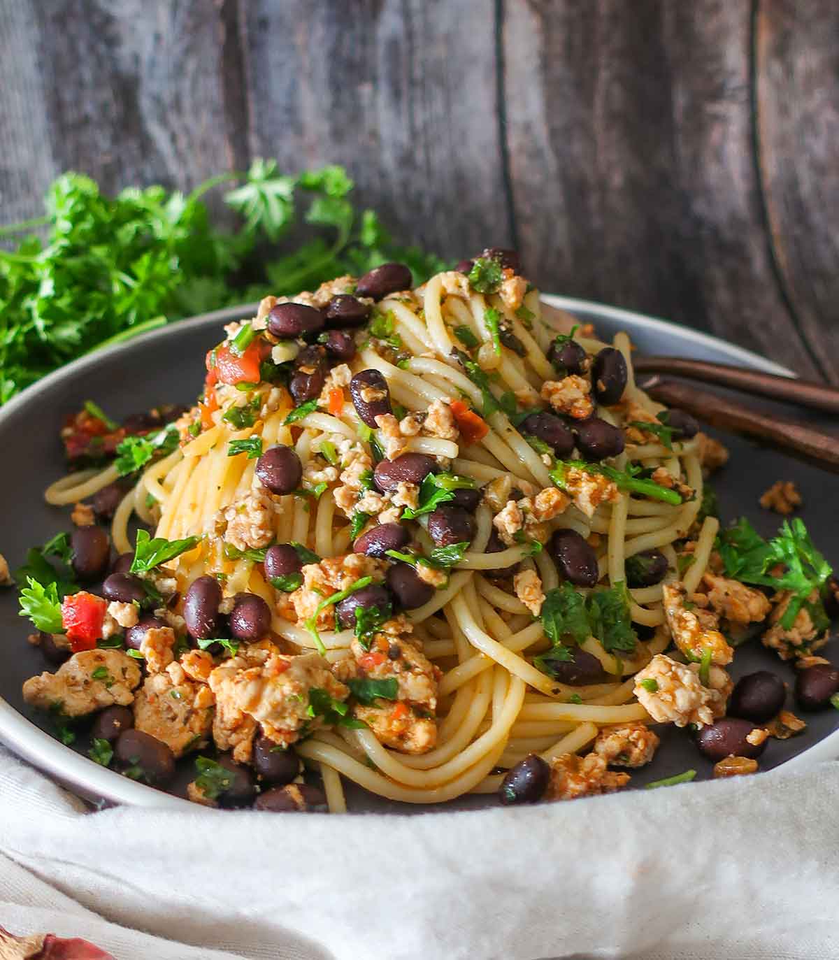 close up of Italian pasta with black beans, ground chicken and parsley