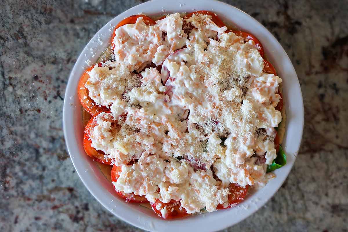 uncooked tomato pie in a pie dish 