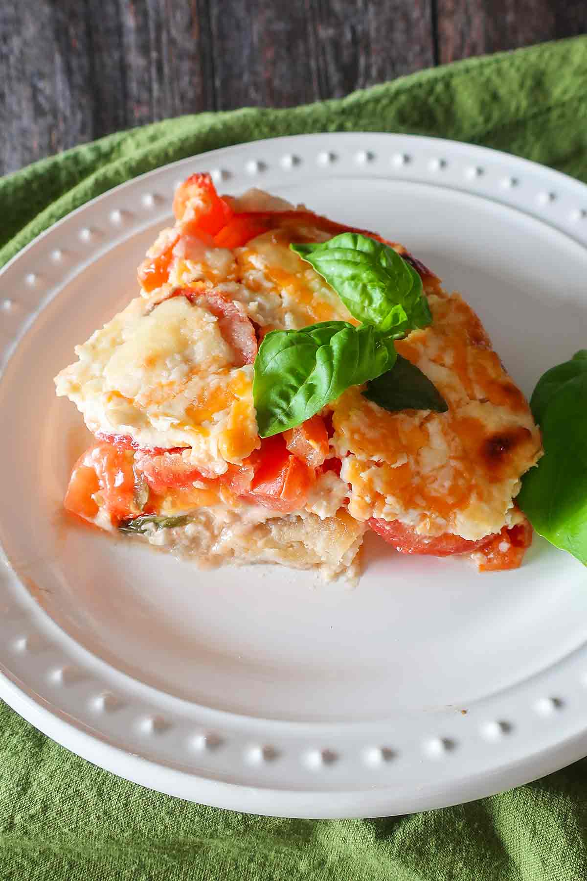 slice of gluten free tomato pie on a plate