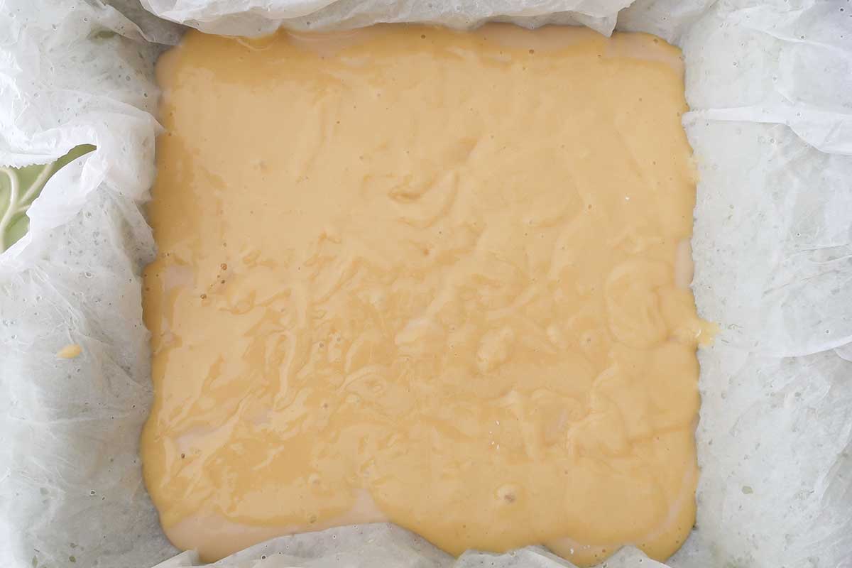 vanilla cake batter in a square pan