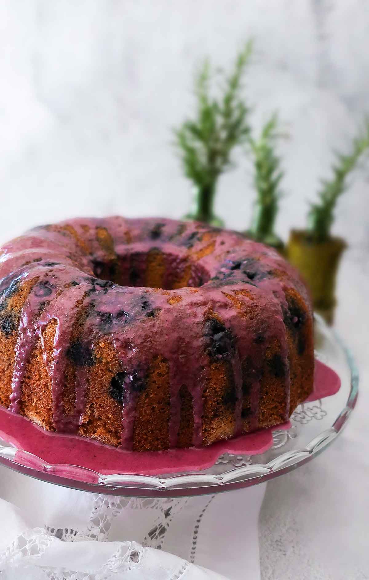 blueberry bundt cake topped with blueberry orange glaze