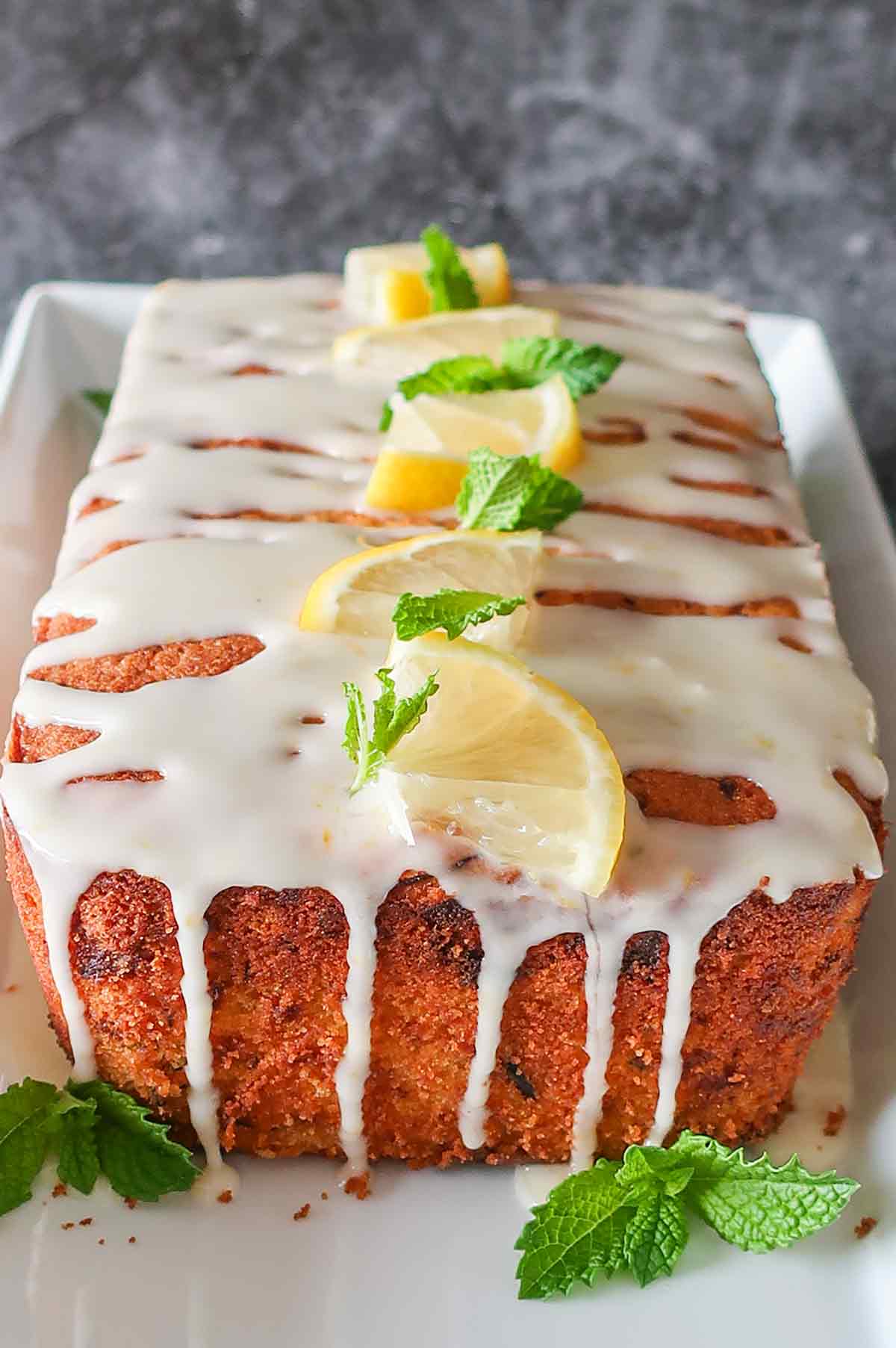 zucchini lemon rice flour loaf with lemon glaze dripping down the sides