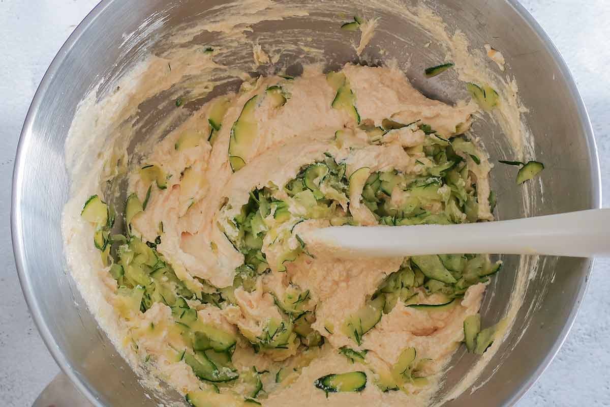 rice flour batter mixed with grated zucchini in a bowl