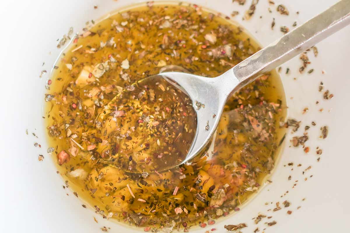 seasoned olive oil with garlic and herbs in a bowl