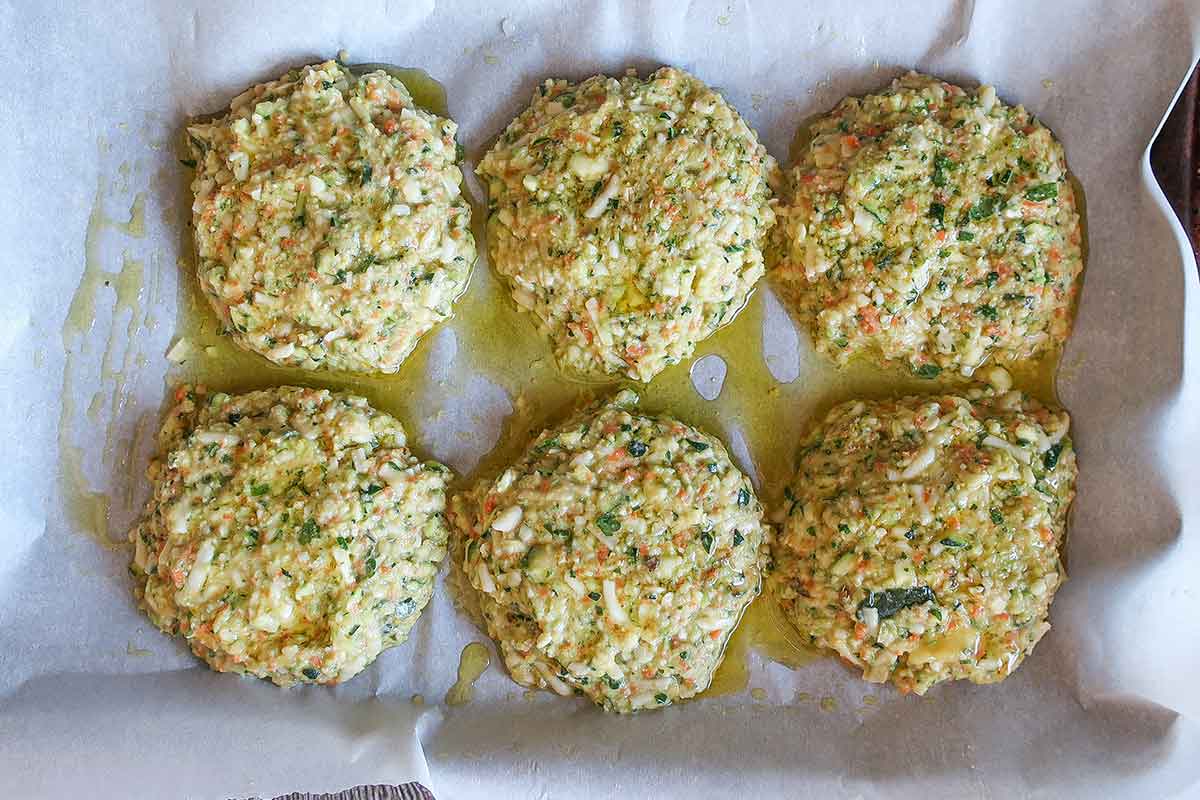 uncooked veggie patties on a baking sheet lined with parchment paper