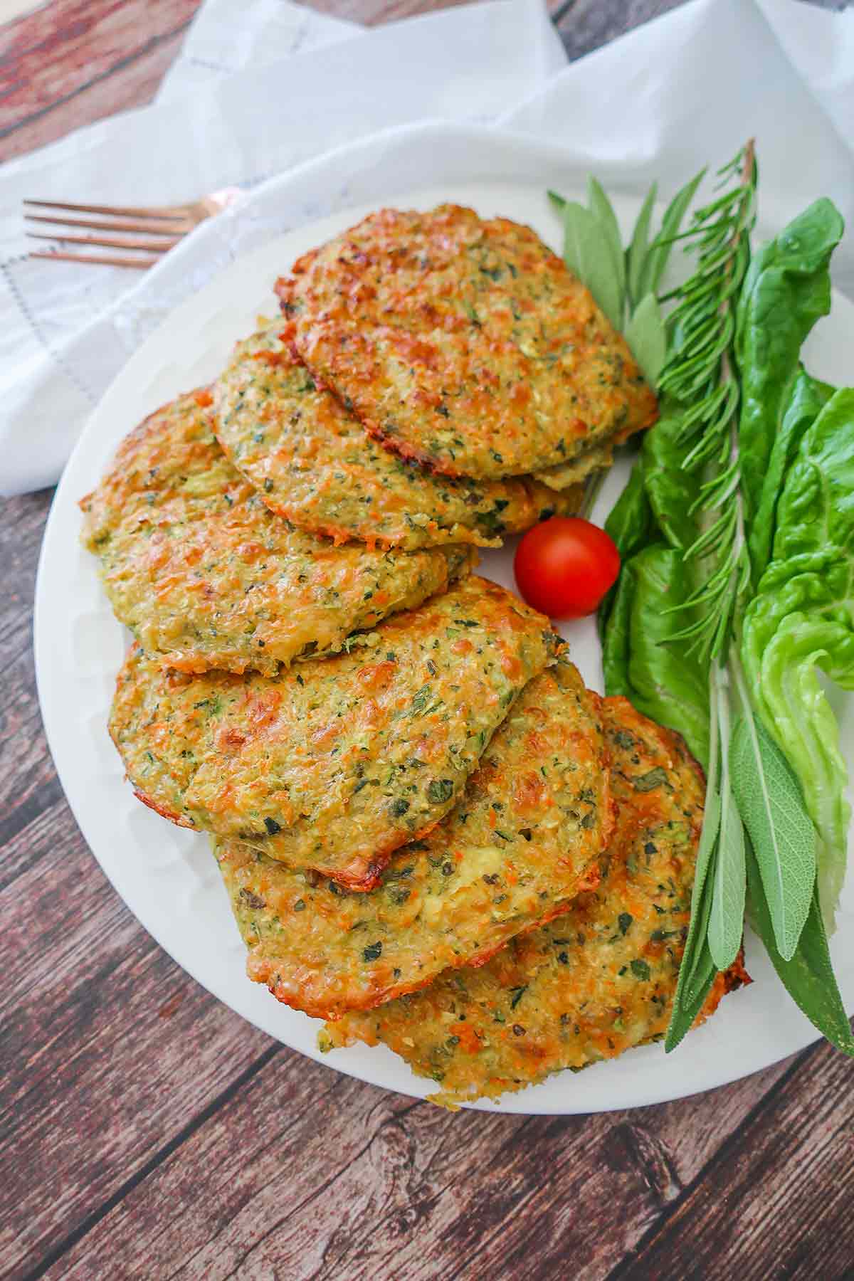 6 baked cheesy veggie patties on a plate