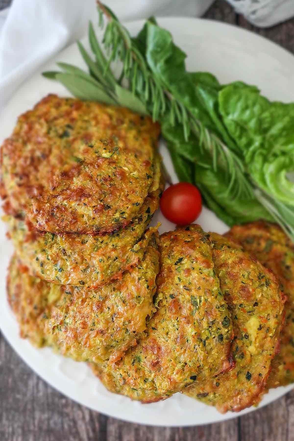 baked cheesy veggie patties on a plate with side of lettuce