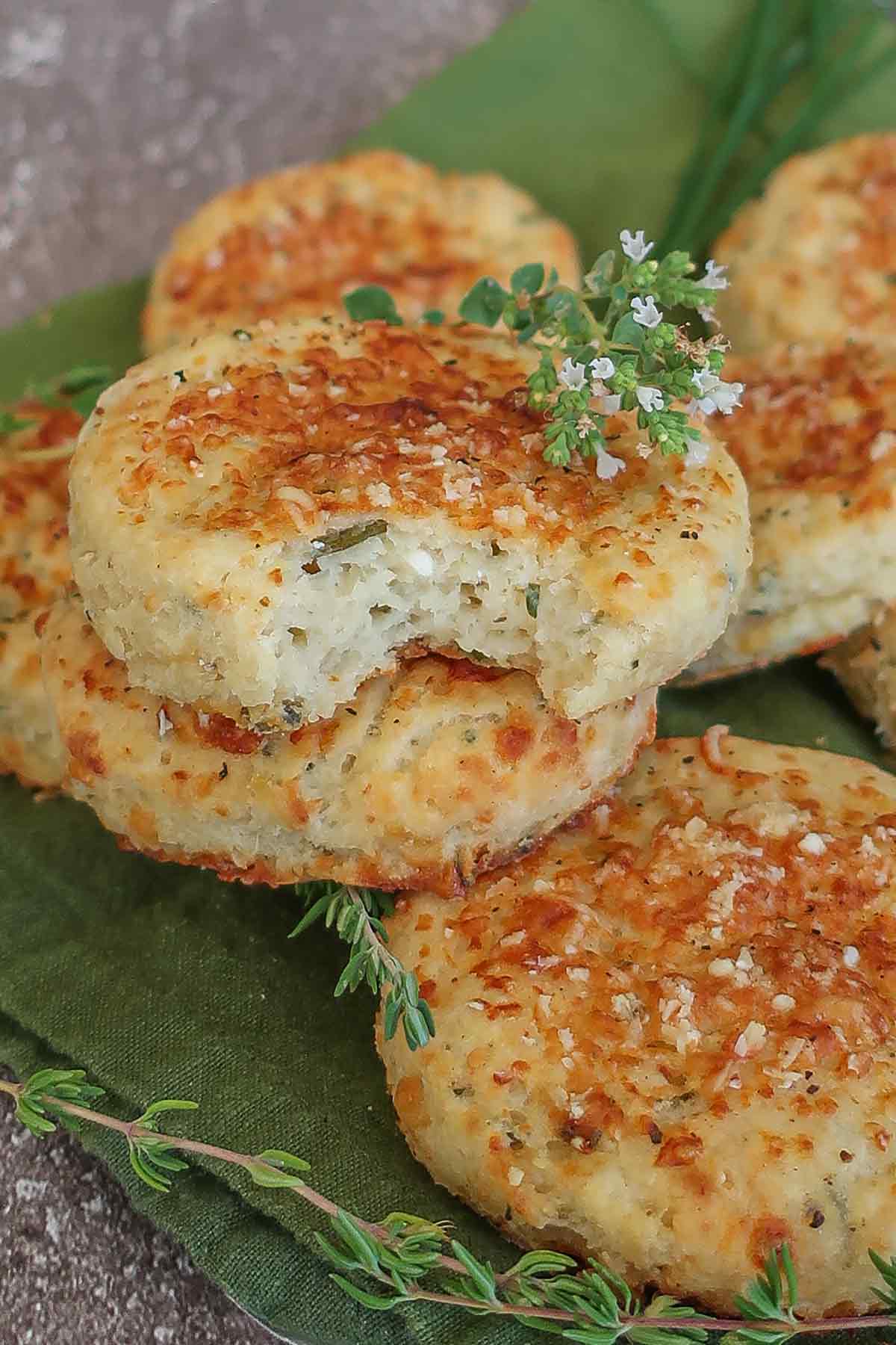 bite taken out of a gluten free sweet potato parmesan biscuit