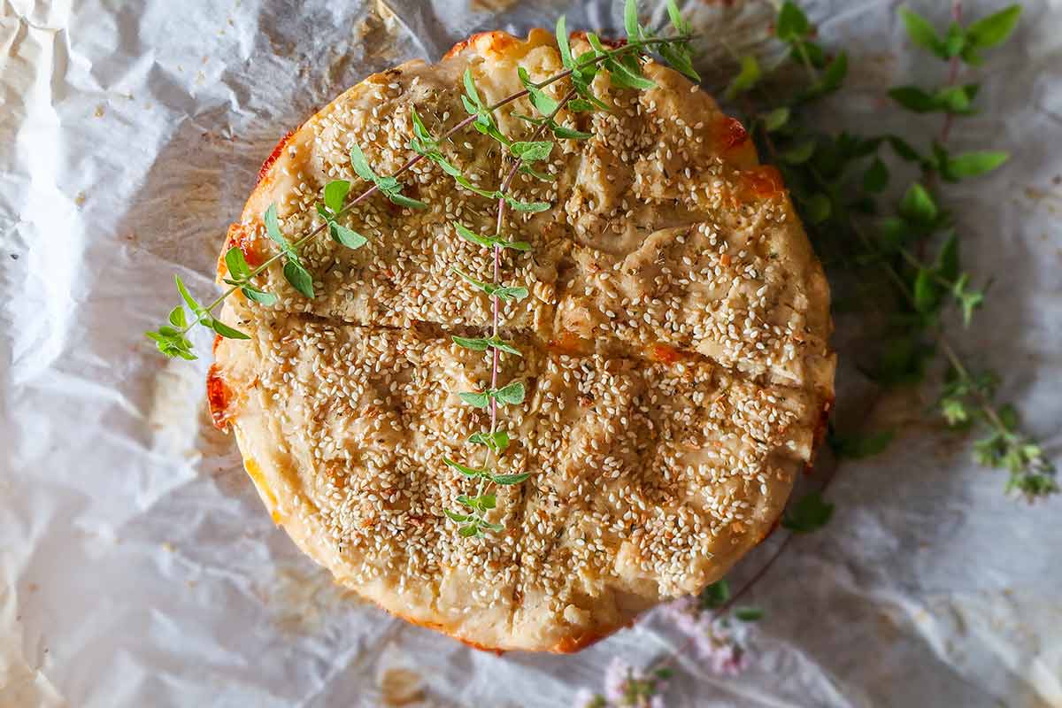 top of baked cheese bread topped with fresh oregano