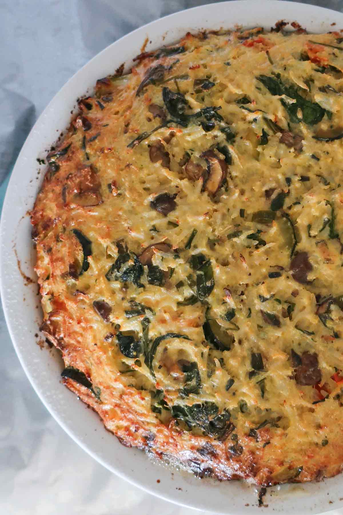 showing bake veggie rice pie in a pie dish