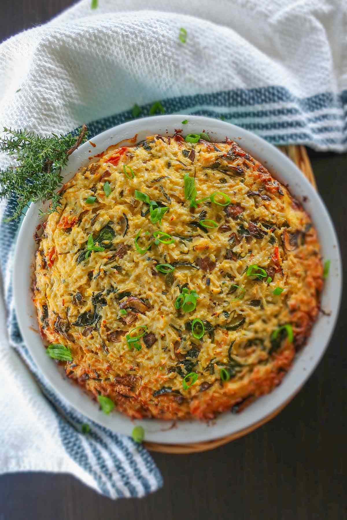 top view of baked veggie rice pie in a pie dish