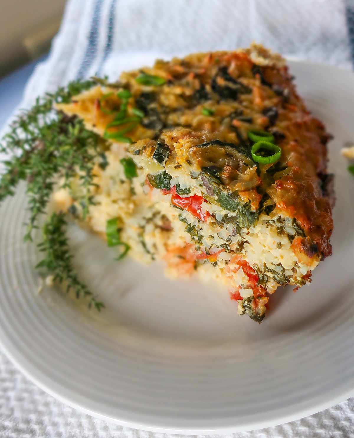 close up of slice of veggie rice pie on a plate