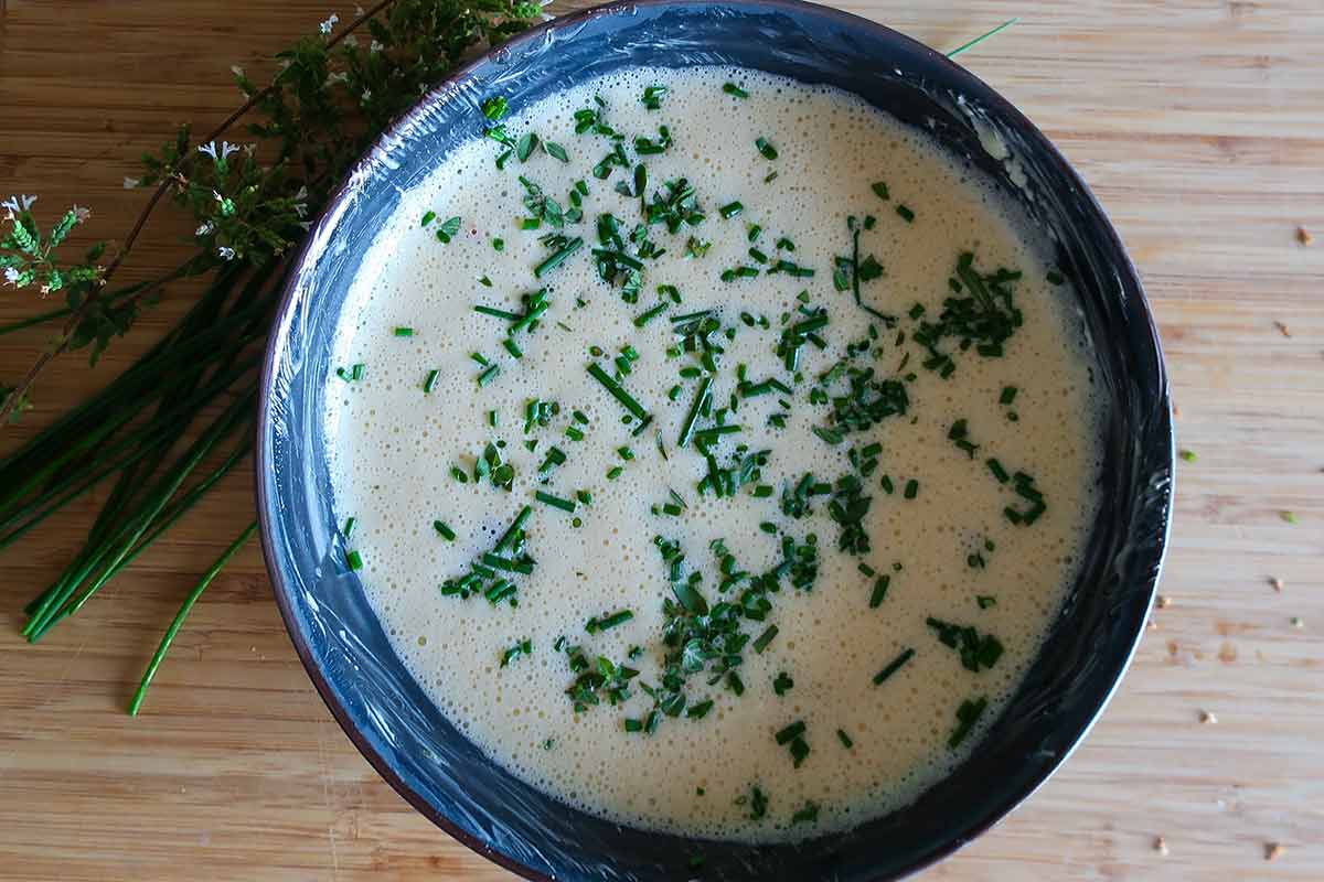 egg mixture with herbs in a bowl 