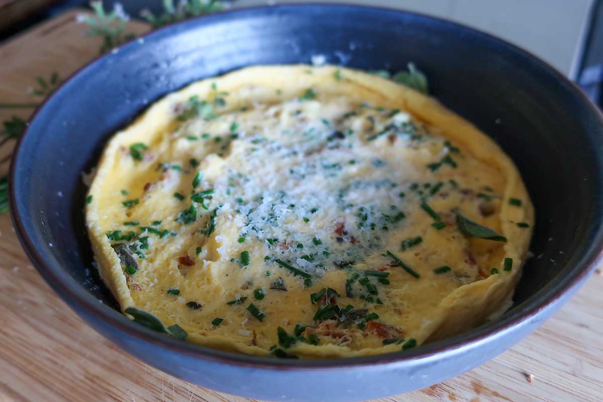 microwaved egg mixture topped with parmesan in a bowl