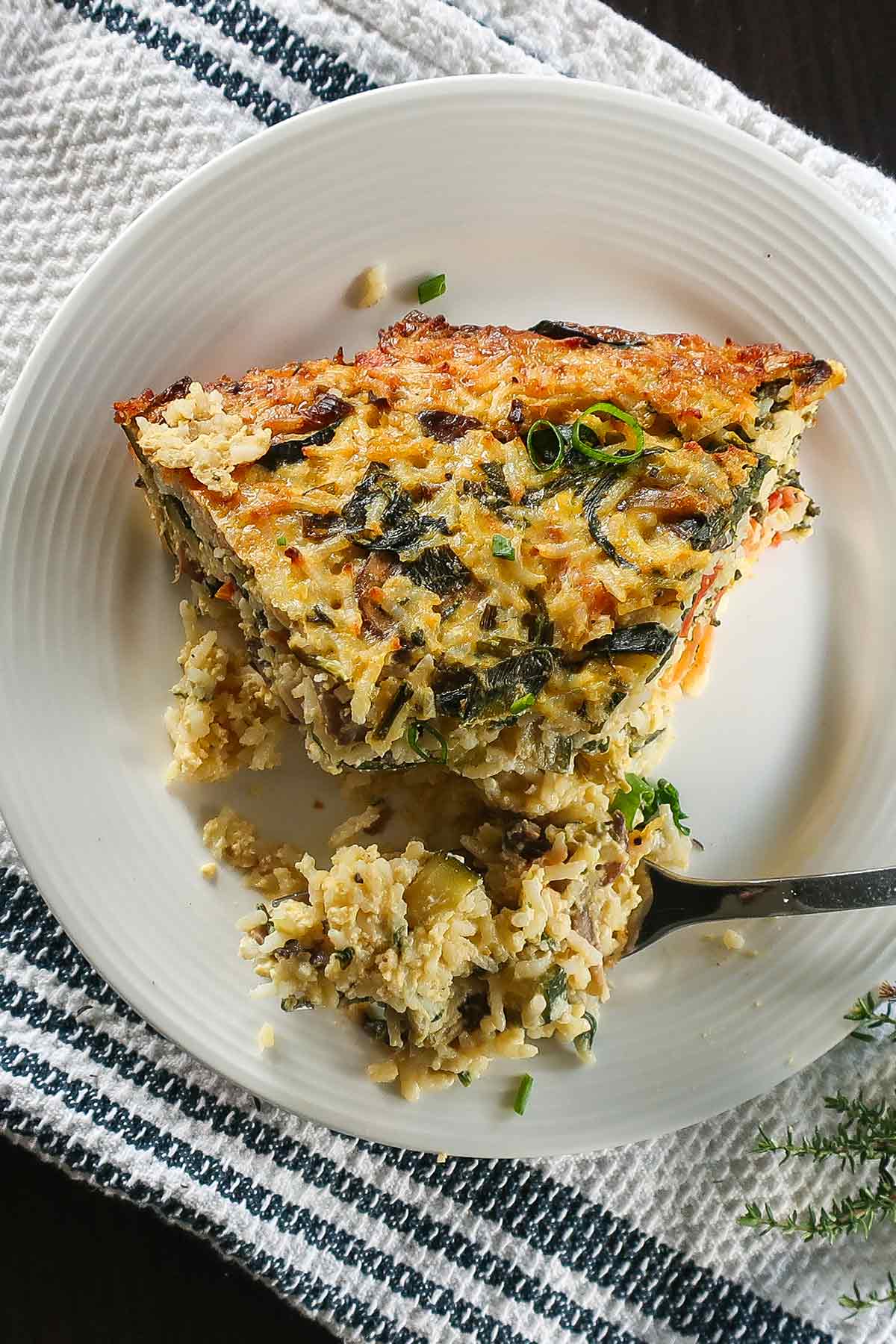 a slice of gluten free veggie rice pie on a plate