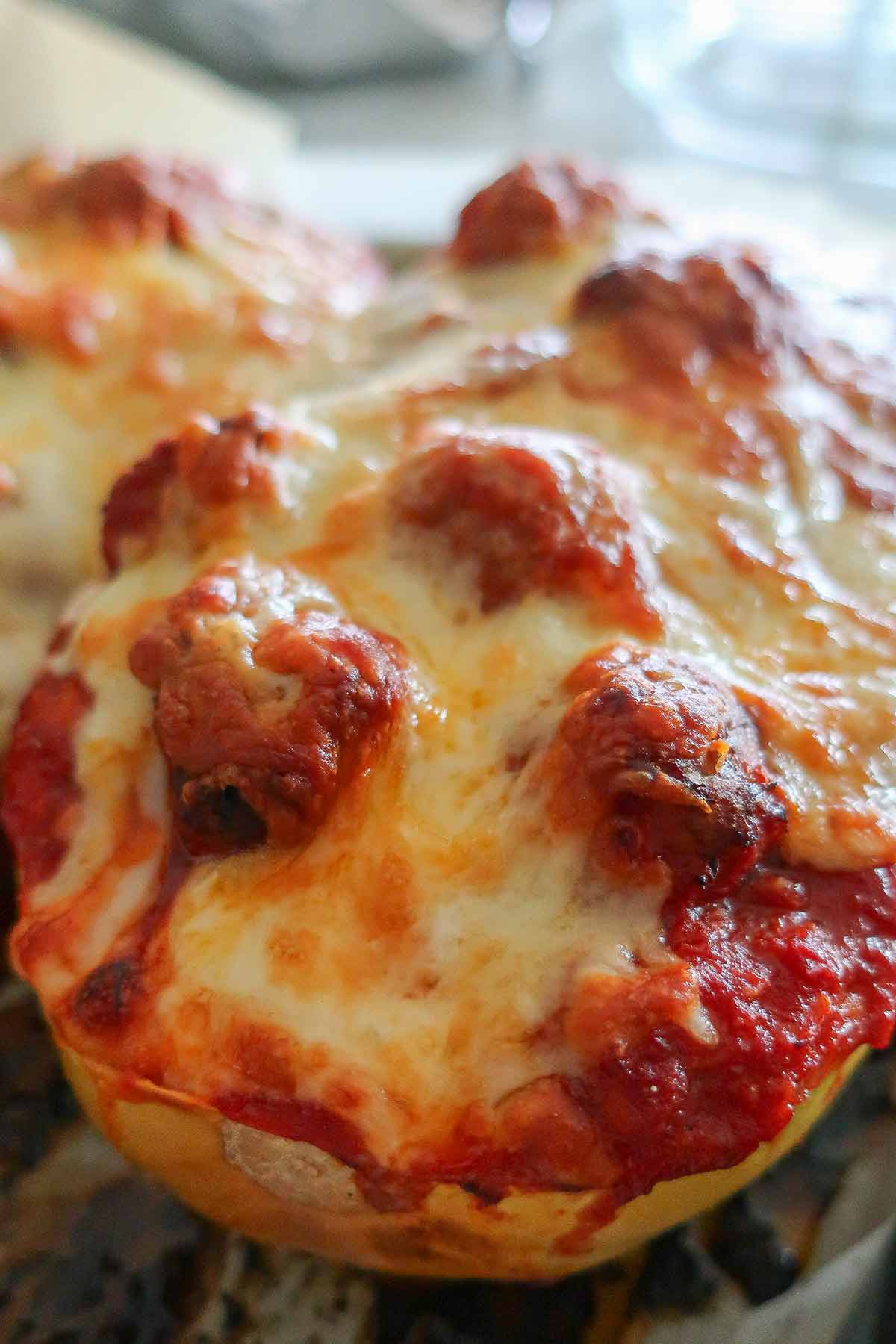 top view showcasing gooey cheese over meatballs in a squash