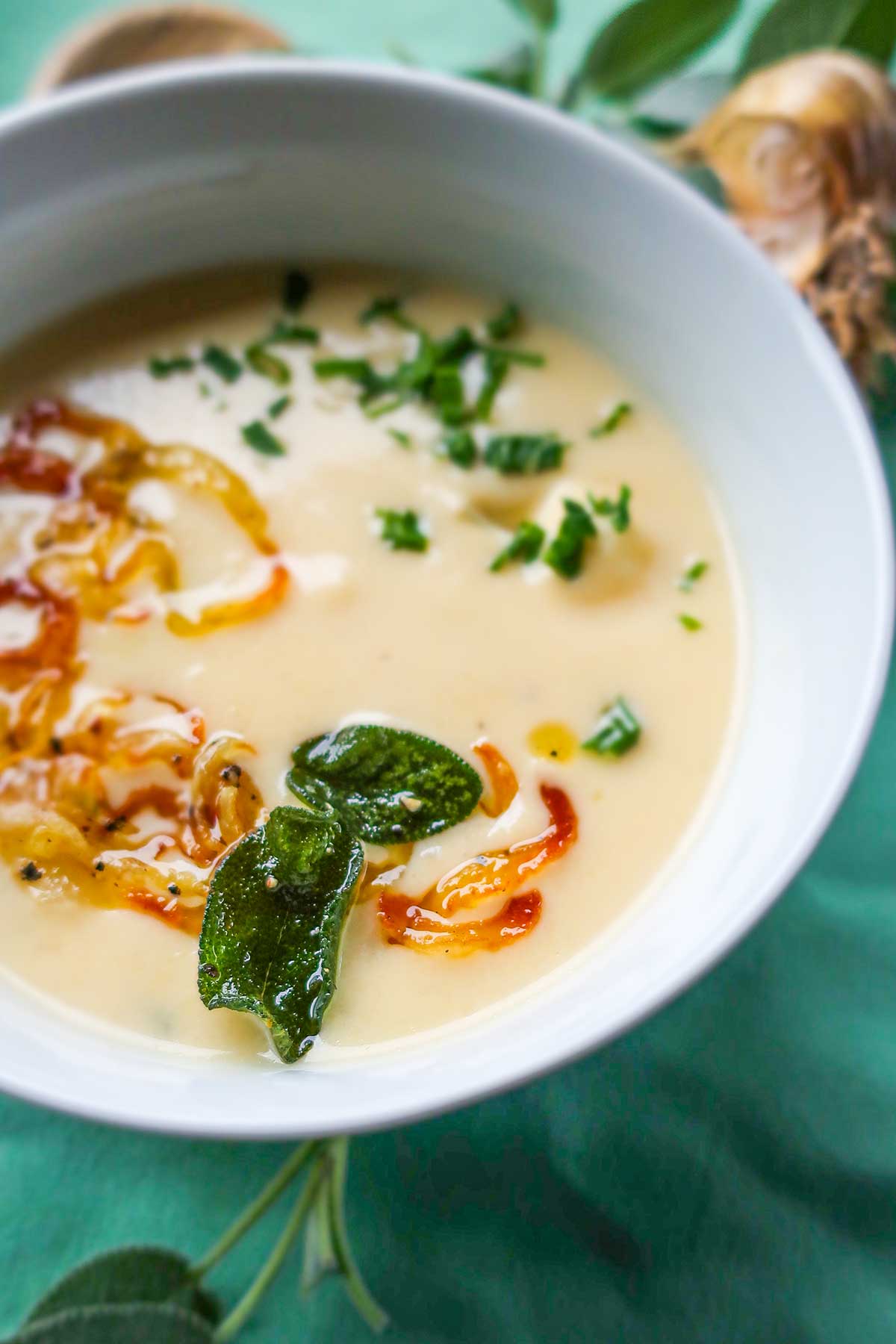 Cheesy Cauliflower Soup with Crispy Sage-Onion Topping in a bowl