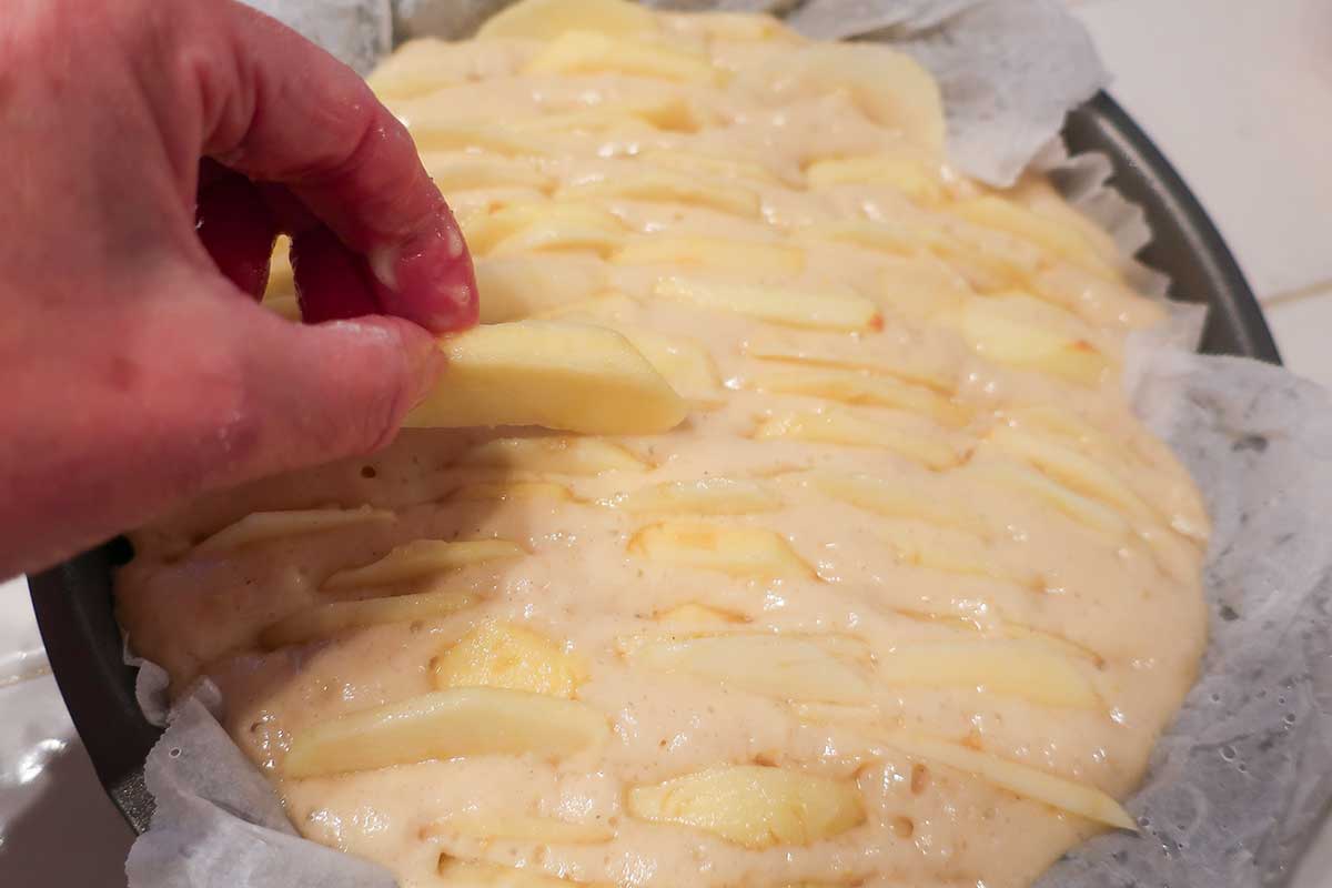 arranging apples in the cake batter