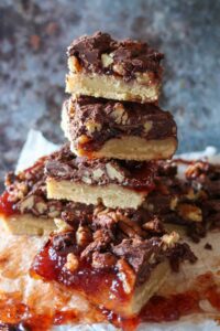 4 stacked gluten-free twix squares on a wooden board