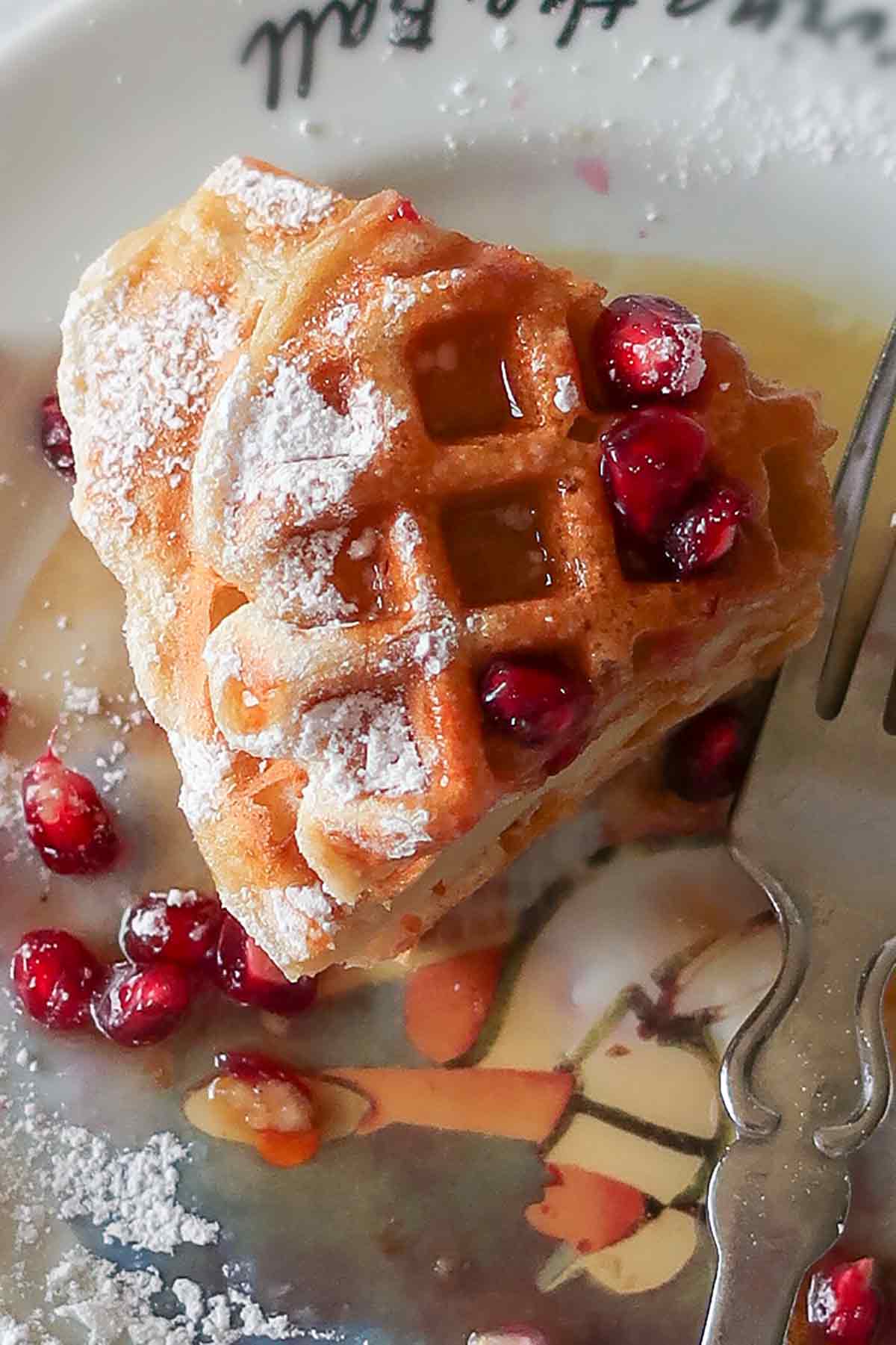 close up of waffles on a plate with toppings