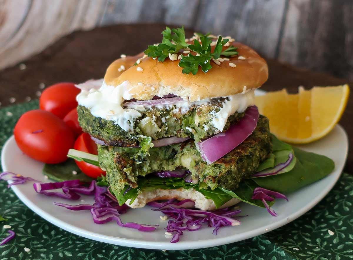 a bite taken out of grain-free veggie patties in a bun