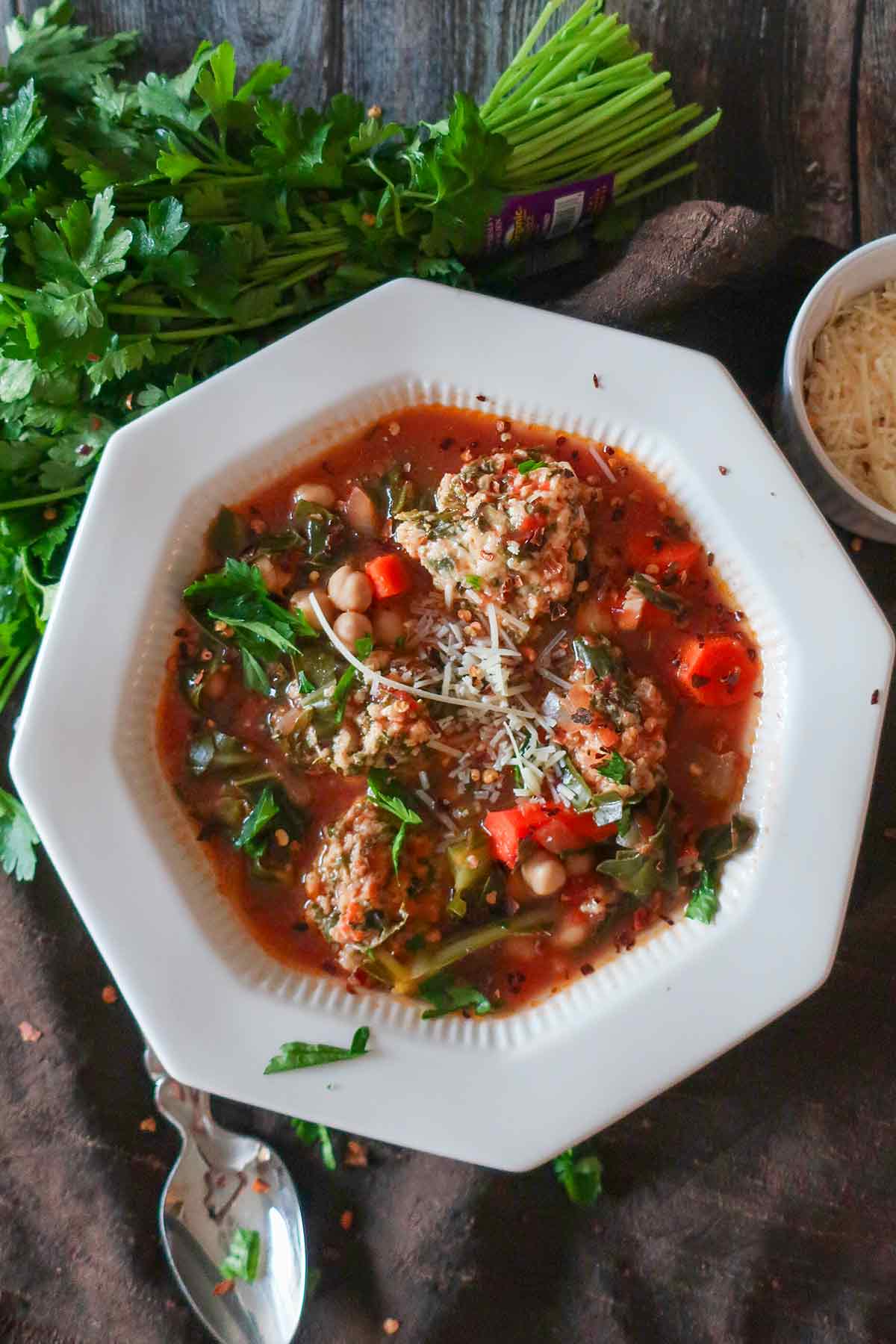serving a bowl of Sicilian chickpea soup with dumplings and toppings