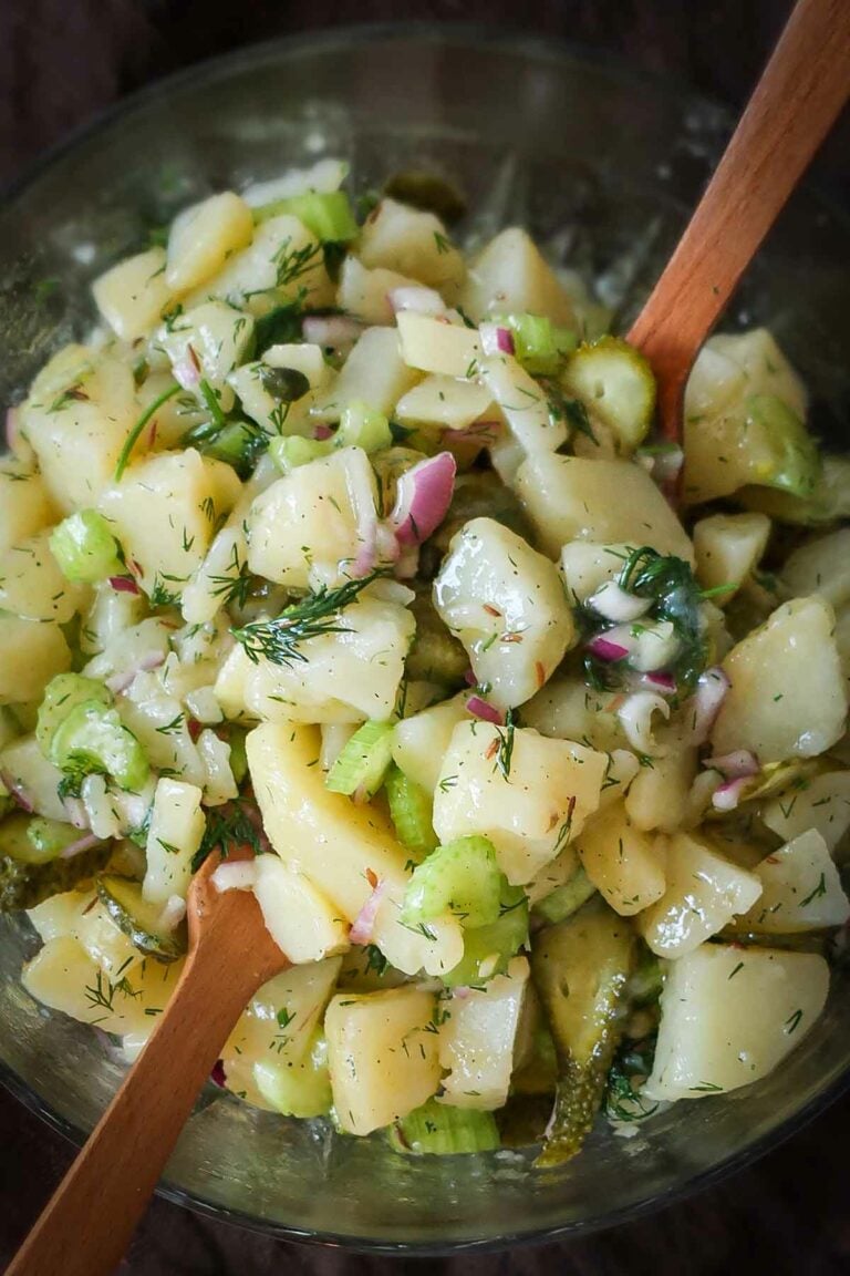 potato salad with pickles, celery, capers, dill and vinaigrette in a bowl