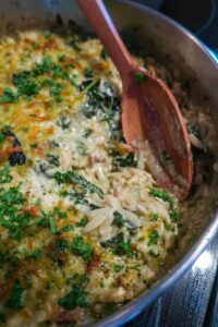 gluten-free pesto chicken and orzo in a skillet