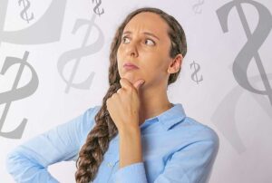 woman thinking about a budget, dollar signs in the background