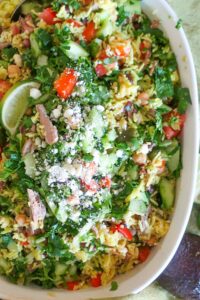 Mexican beef and rice salad topped with feta and fresh herbs