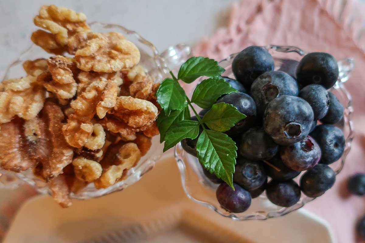 walnuts and blueberries in clear glasses