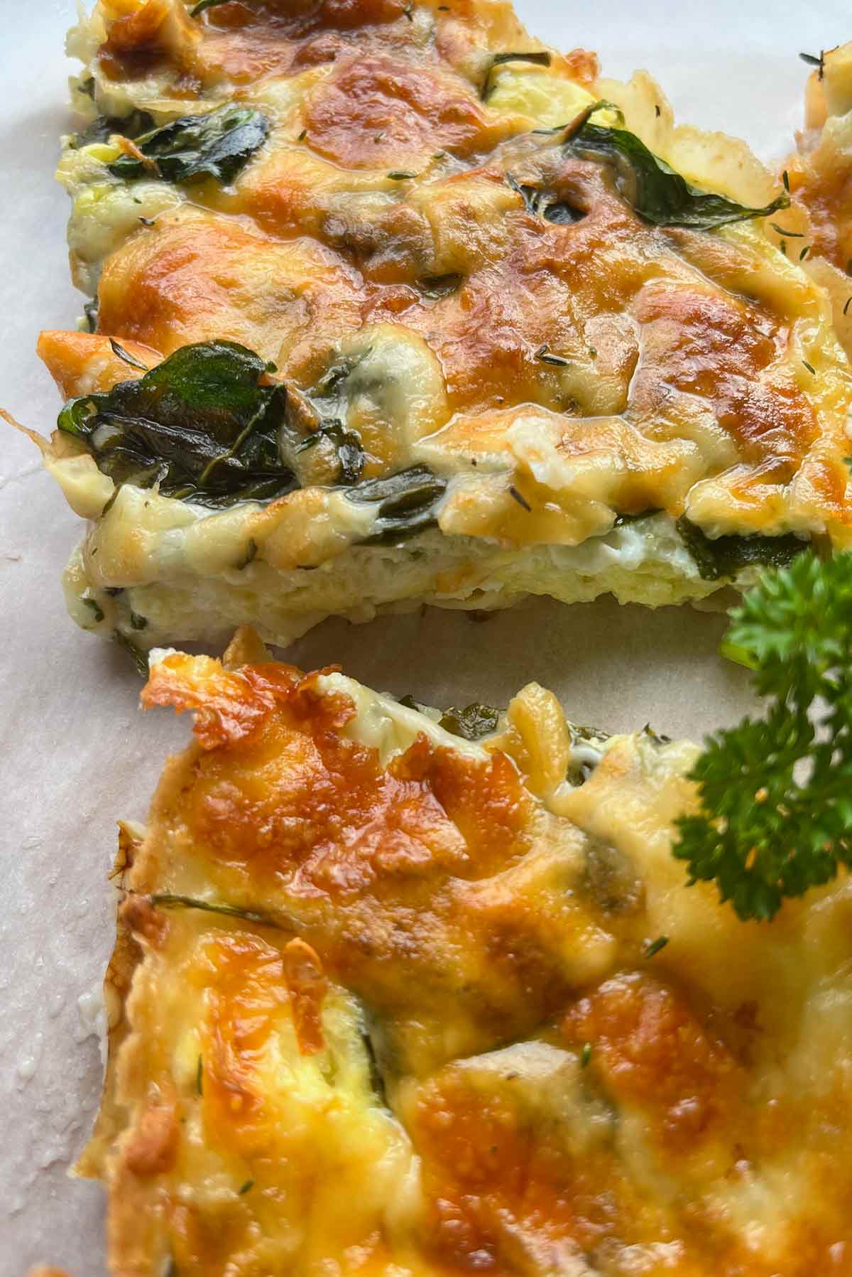 Close-up of two slices of breakfast tortilla quiche