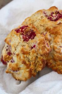 3 gluten free raspberry buttermilk scones on a plate that were baked in an air fryer