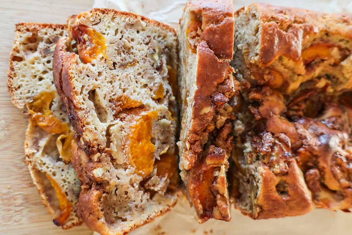 slices of apricot walnut quick bread loaf showcasing chunks of apricots