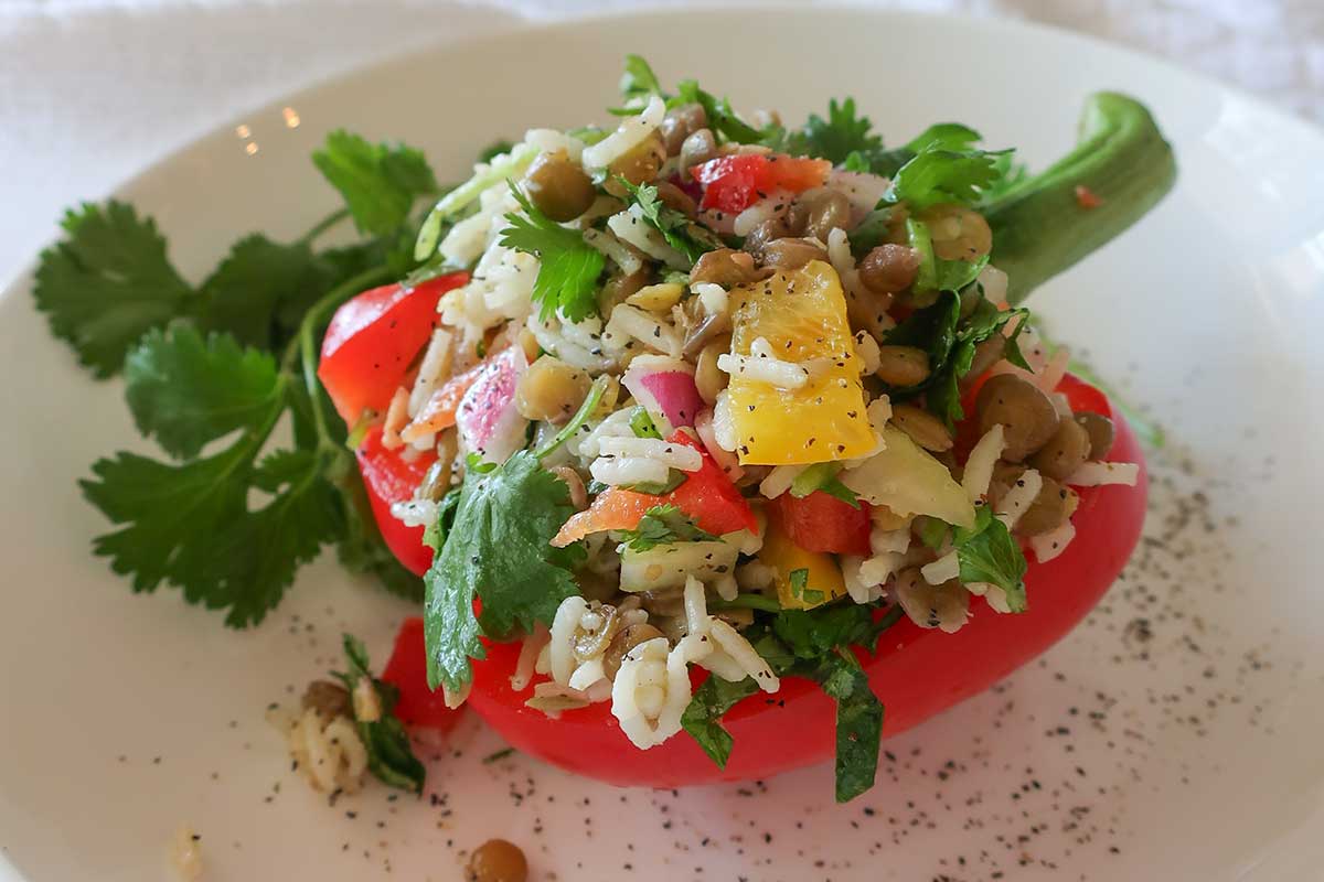 lentil and rice veggie summer salad stuffed in half a bell pepper