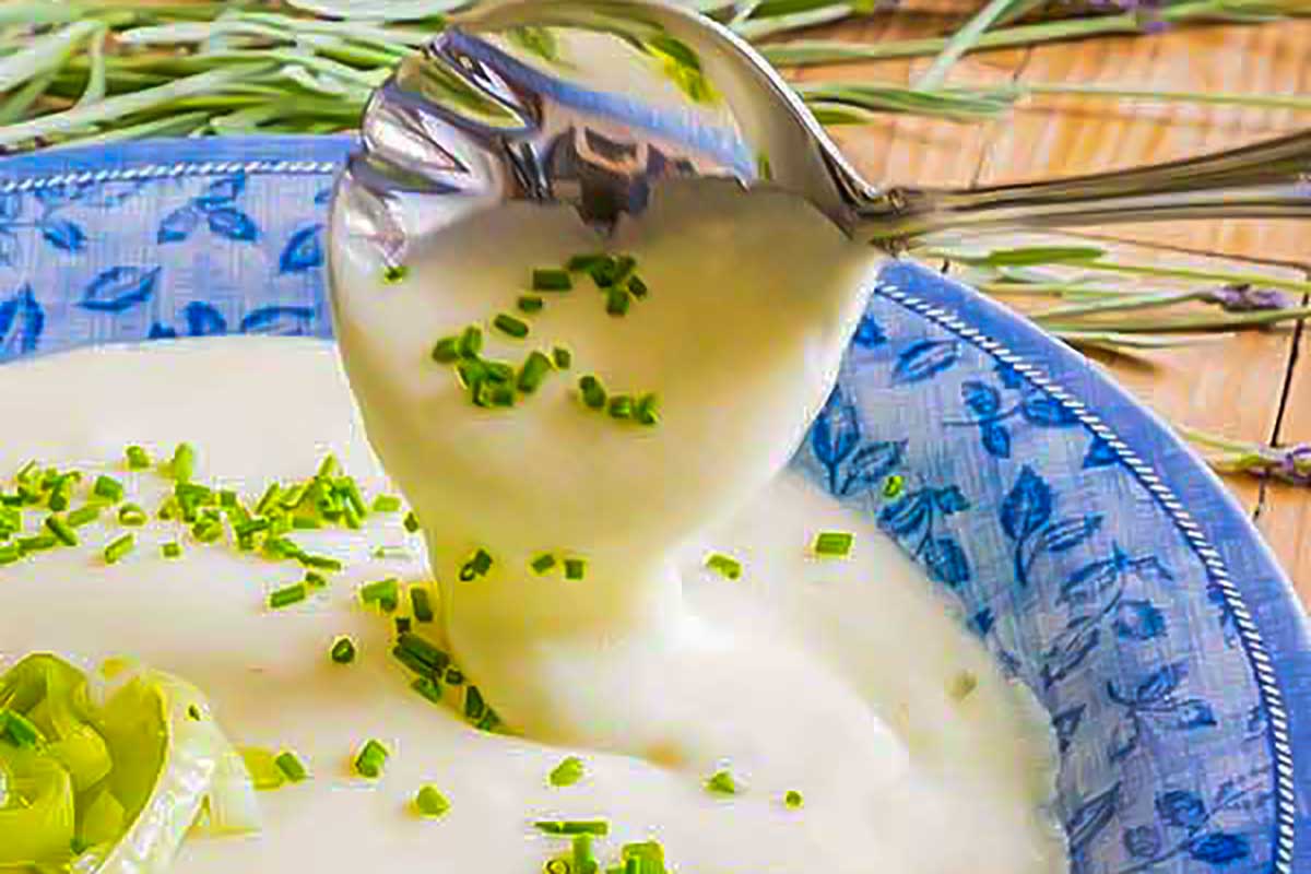 dairy-free cold vichyssoise soup in a bowl topped with chives
