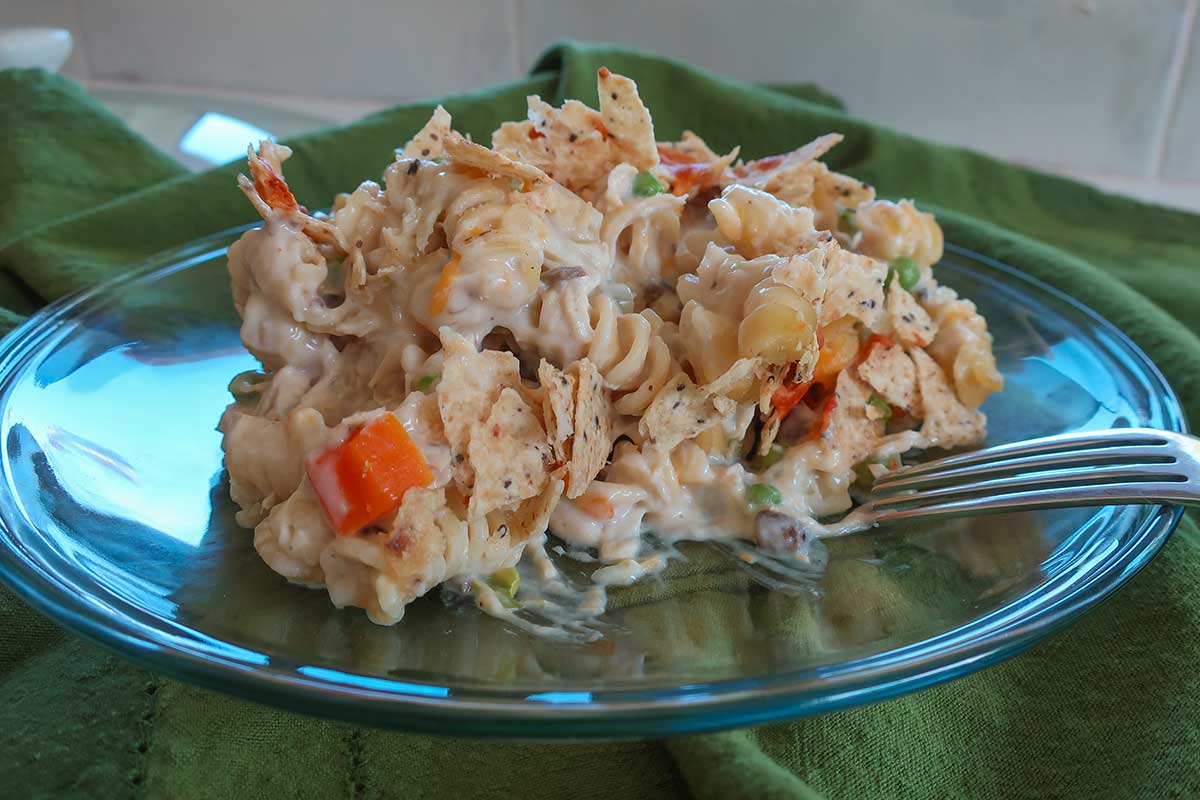 chicken noodle casserole with veggies in a cream sauce on a small plate with 