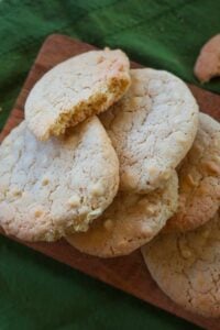 Gluten-free chocolate chip millet cookies with one broken open to show soft, crumbly texture